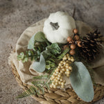 white pumpkin and pinecone arrangement